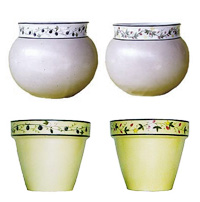 A selection of glazed ceramic pots with a hand painted design